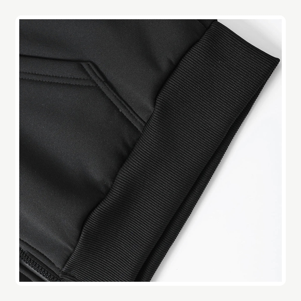 Black hoodie pocket and ribbed cuff close-up