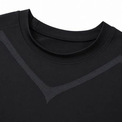 Close-up of the black compression tank's round neckline and charcoal dotted chest pattern.