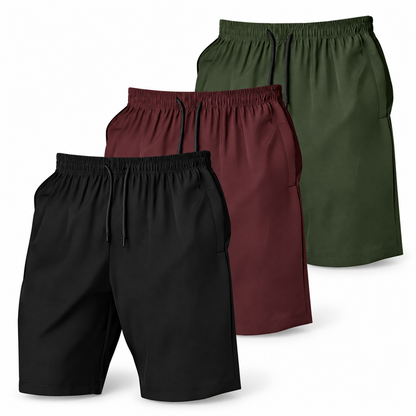 Three-pack of men’s shorts in black, burgundy and olive with elastic waists and black drawstrings.