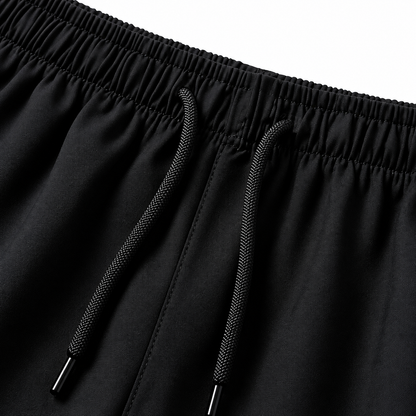 Close-up of the black shorts’ gathered elastic waistband and two black drawstrings.