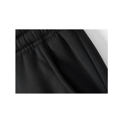 Black jogger pocket and gathered waistband seam close-up