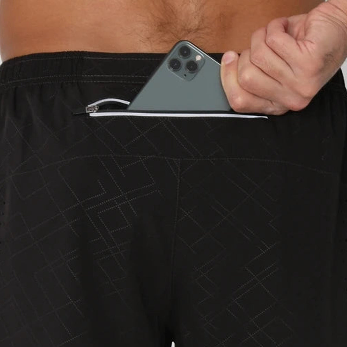 Rear zip pocket on the Black Stripe running shorts, with a phone visible at the opening.